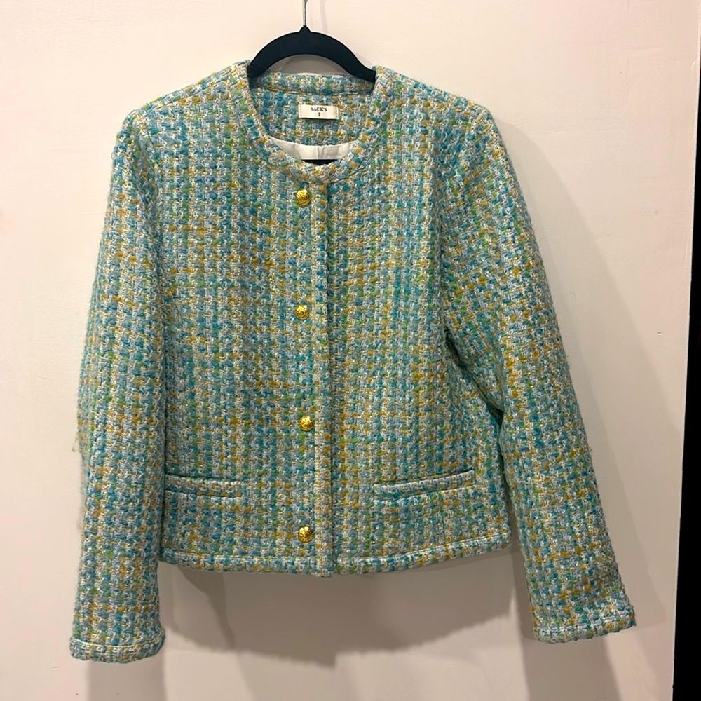 Women’s tweed jacket with gold buttons.